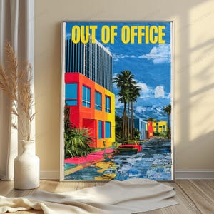 May include: A vertical wall art print featuring the text OUT OF OFFICE in yellow letters. The image depicts a vibrant city street with a tall building, colorful red and yellow facades, palm trees, a red car, and a blue sky with clouds.