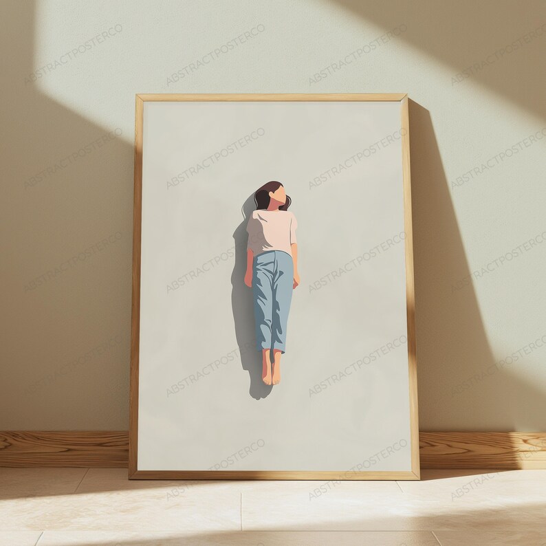 May include: A framed wall art print featuring a minimalist illustration of a person floating in a vertical position. The figure wears a light pink short-sleeved shirt and blue trousers, set against a solid, neutral beige background.