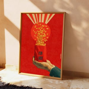 May include: A framed vertical poster featuring a red background with a stylized sunburst design. A pair of hands holds a red envelope with dark blue Chinese characters, from which a stream of golden coins flows upward toward the sun.