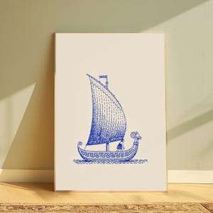 May include: A framed wall art print featuring a blue line drawing of an ancient Greek ship with a single sail and a decorative meander pattern along the hull. A small figure stands on the deck of the vessel, which is set against a cream background.