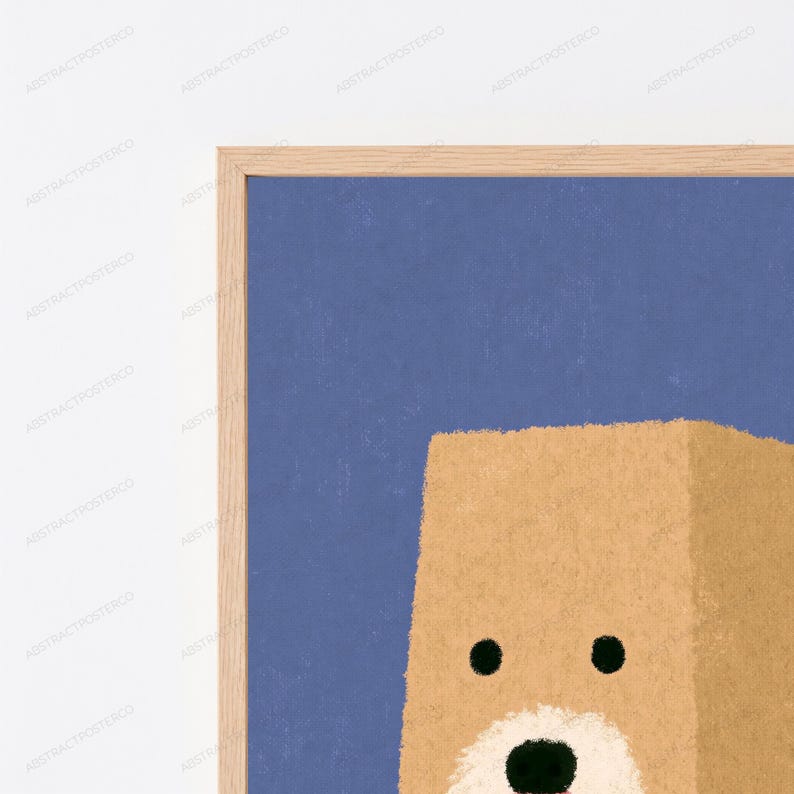 May include: A framed wall art print featuring a stylized tan bear head against a solid blue background. The bear has two small black circular eyes, a white muzzle area, and a small black nose. The frame is made of light-colored natural wood.