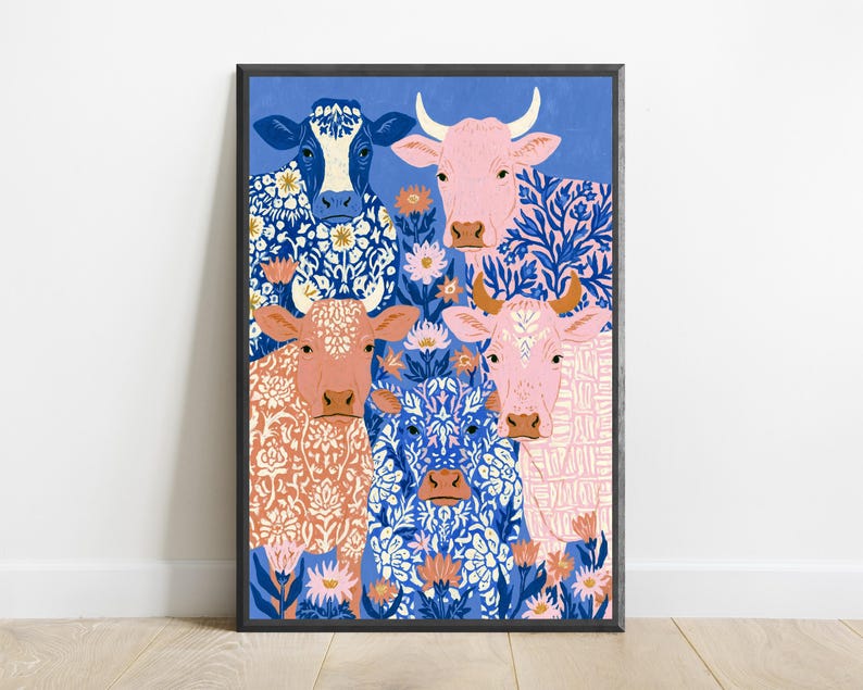May include: A framed vertical art print featuring four cows against a blue background. The cows are decorated with intricate white and blue floral and geometric patterns. The cows are coloured in shades of blue, light pink, and peach, surrounded by flowers.