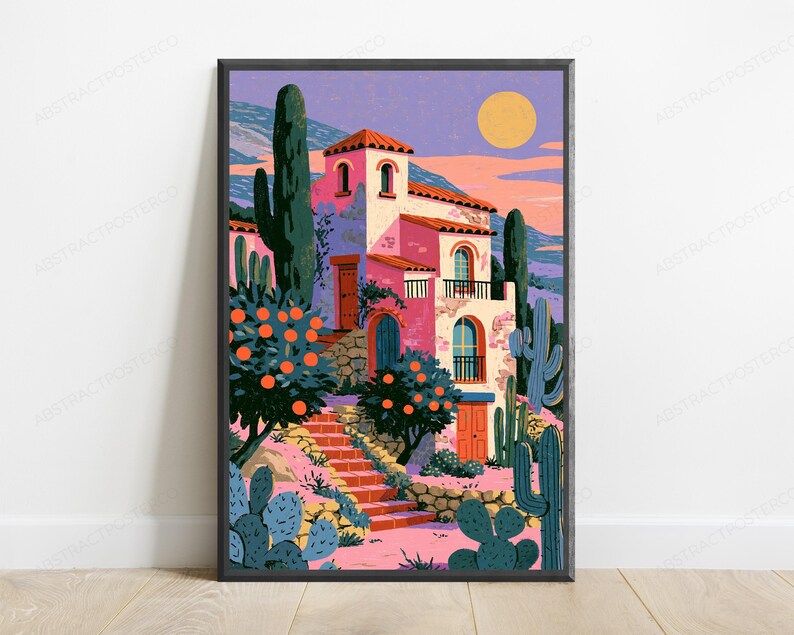 May include: A framed art print depicting a multi-story pink villa with a red tiled roof, surrounded by orange trees and various cacti. A stone staircase leads to the entrance under a yellow sun in a purple sky, featuring a landscape of distant hills.