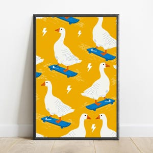 May include: A framed art print featuring a repeating pattern of white geese with orange beaks and feet riding blue skateboards on a vibrant mustard yellow background, interspersed with small white lightning bolt icons throughout the design.