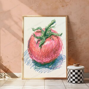 May include: A framed wall art print featuring a crayon-style drawing of a single red tomato with a prominent green stem. The artwork uses textured, layered strokes in shades of red, pink, and green against a light, off-white background.