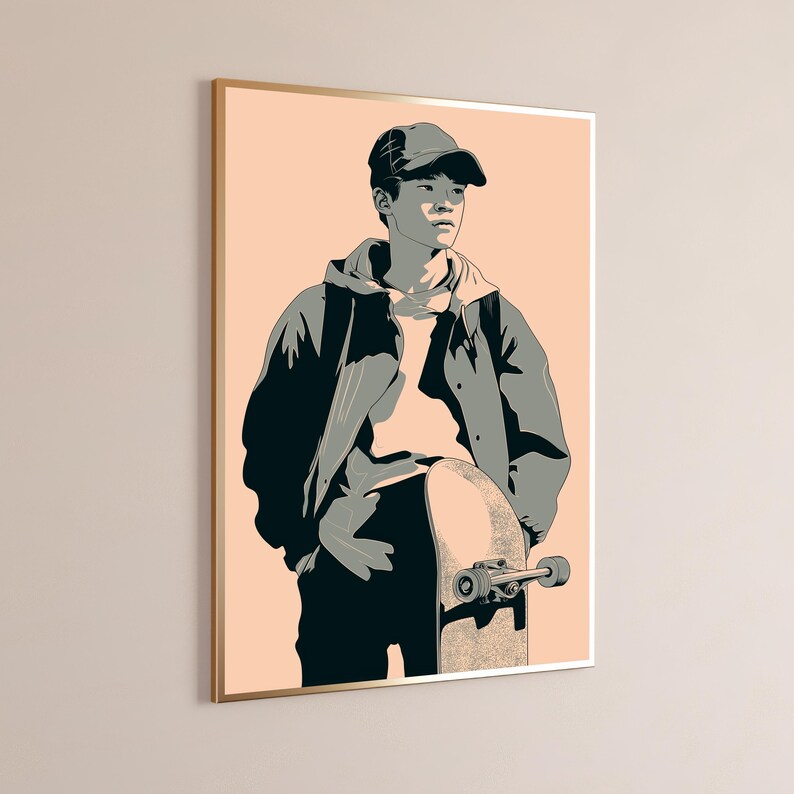 May include: A framed wall art print featuring a stylized illustration of a person wearing a baseball cap and a hooded jacket, standing while holding a skateboard. The artwork uses a palette of peach, dark gray, and light gray tones.