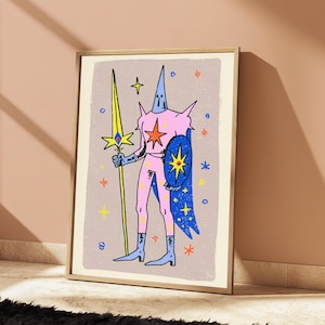 May include: A framed art print featuring a stylised illustration of a figure in a pink suit with a pointed hood, holding a long yellow spear and a blue shield. The figure is adorned with star motifs against a light purple background with scattered stars.