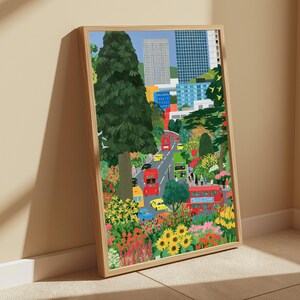 May include: A framed vertical art print depicting a city street scene with red double-decker buses, yellow taxis, and blue cars surrounded by lush green trees and vibrant flowers, set against a backdrop of tall modern skyscrapers and buildings.