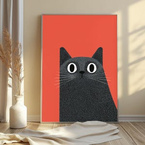 May include: A rectangular framed wall art print featuring a stylized illustration of a black cat with large white eyes and long white whiskers set against a solid, vibrant orange background. The cat has a textured appearance with fine lines.