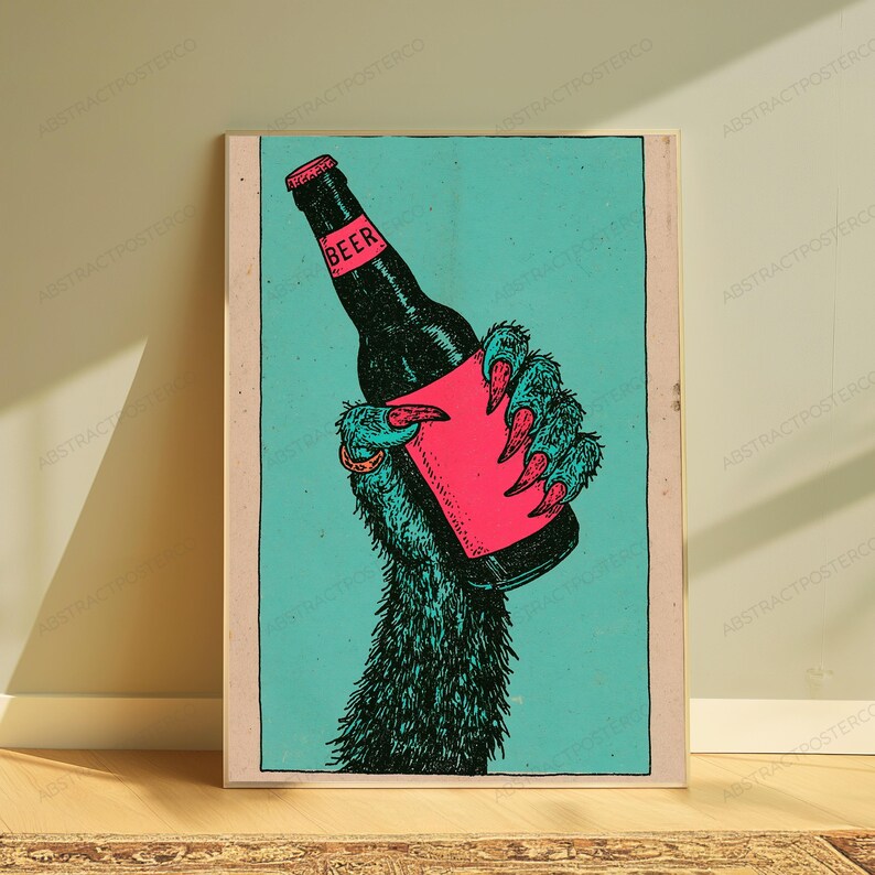 May include: A rectangular art print featuring a stylised illustration of a furry, clawed hand holding a dark beer bottle. The background is a solid teal colour, while the bottle label and the hand's sharp claws are rendered in a vibrant, solid pink.