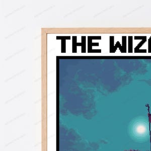 May include: A framed wall art print featuring pixel art style graphics. The top of the print displays the text THE WIZ in bold black pixelated letters. Below the text is a dark teal and blue sky with a bright white circular moon.