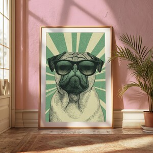 May include: A framed wall art print featuring a detailed illustration of a pug dog wearing black sunglasses. The pug is centered against a background of radiating light green and cream-colored sunburst rays, creating a graphic, high-contrast visual.