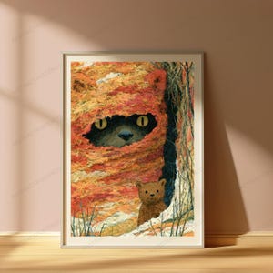 May include: A framed art print featuring a dark-furred creature with bright yellow eyes peeking out from a textured, orange and red knitted hood, with a small brown teddy bear standing in the foreground against a dark, shadowed background.