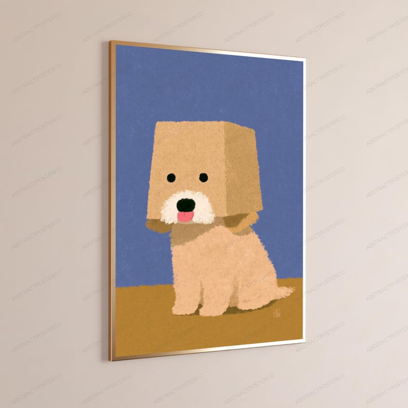 May include: A framed wall art print featuring a tan, fluffy dog with a square paper bag over its head. The dog has a white muzzle, a black nose, and a pink tongue sticking out. The background is a solid blue sky above a solid tan ground.