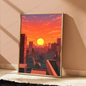 May include: A rectangular framed wall art print featuring a digital illustration of a city skyline at sunset. The scene displays a bright yellow sun centred above dense urban buildings, with a vibrant orange and red sky filled with soft clouds.