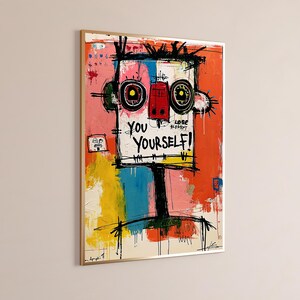 May include: A framed abstract painting featuring a stylized face with large circular eyes, a red nose, and bold black outlines. The artwork includes vibrant blocks of orange, yellow, blue, and pink, with the text YOU YOURSELF! and LOSE written in black.