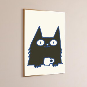 May include: A framed wall art print featuring a stylized black cat with large white eyes and a blue outline. The cat is depicted from the chest up, holding a small white mug with both paws. The background of the illustration is off-white.