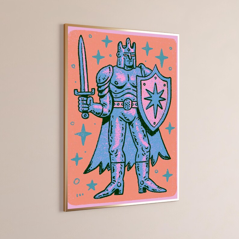 May include: A framed wall art print featuring a stylized illustration of a knight in armor, holding a sword in the right hand and a shield with a star emblem in the left. The figure is rendered in blue and pink tones against a coral background.