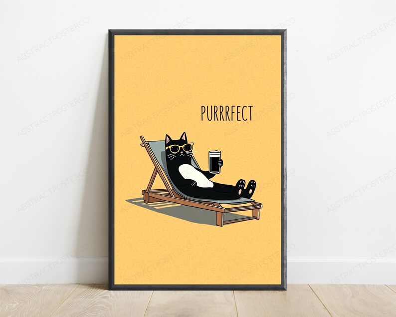 May include: A framed wall art print featuring a black and white cat wearing yellow sunglasses, lounging on a wooden deck chair while holding a dark beverage. The background is a solid yellow color with the text PURRRFECT printed in black above the cat.