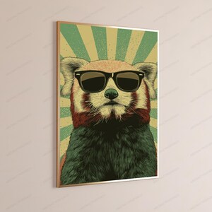 May include: A framed wall art print featuring a stylized illustration of a red panda wearing black sunglasses. The background consists of a sunburst pattern in alternating shades of light green and beige, with a textured, vintage-inspired aesthetic.