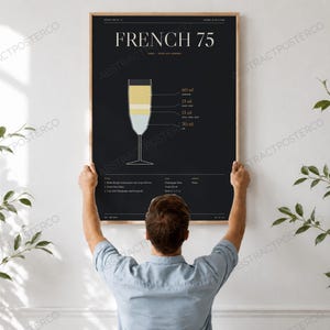 French 75 Cocktail Recipe Print, held up in a room