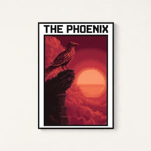 Puede incluir: Una impresi&oacute;n de arte mural rectangular con pixel art de un p&aacute;jaro posado en un acantilado rocoso frente a un gran sol naranja y nubes rojas. El texto THE PHOENIX est&aacute; impreso en letras negras en la parte superior del marco con borde blanco.