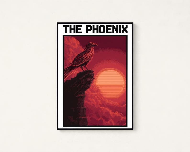 Puede incluir: Una impresi&oacute;n de arte mural rectangular con pixel art de un p&aacute;jaro posado en un acantilado rocoso frente a un gran sol naranja y nubes rojas. El texto THE PHOENIX est&aacute; impreso en letras negras en la parte superior del marco con borde blanco.