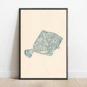 May include: A framed wall art print featuring a textured, blue-green illustration of a flatfish centered on a solid, light cream-colored background. The artwork is enclosed within a simple, thin black frame that borders the entire rectangular print.