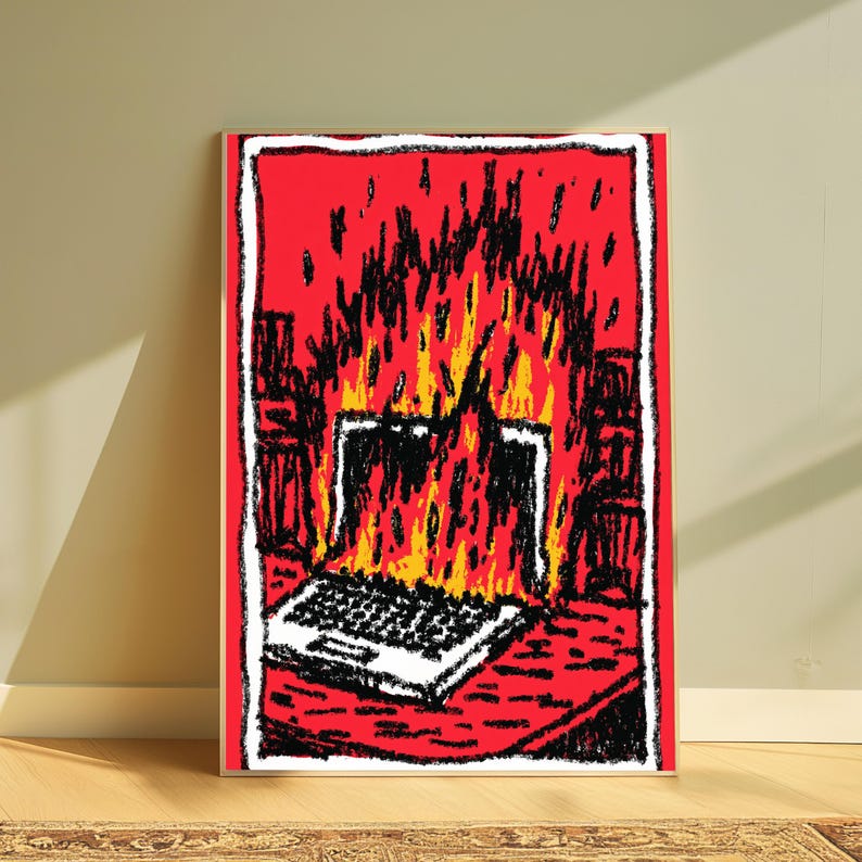 May include: A rectangular art print featuring a stylized illustration of a laptop engulfed in bright orange and yellow flames against a vibrant red background. The drawing uses bold black outlines and a sketch-like texture to depict the burning device.