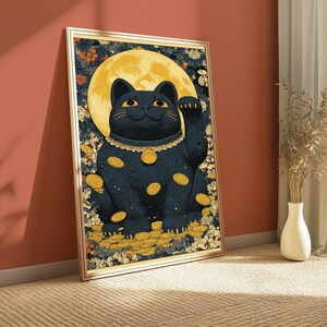 May include: A framed rectangular wall art print featuring a black beckoning cat centered against a large yellow full moon. The cat wears a collar with a bell, surrounded by scattered gold coins and a dense background of small floral patterns.