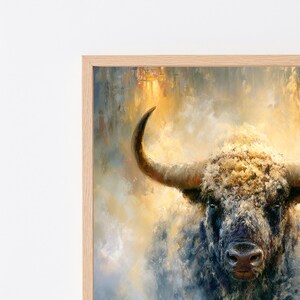 May include: A framed wall art print featuring an impressionistic oil painting of a bull with textured fur in shades of gray, brown, and white. The bull has a prominent curved horn and is set against a soft, glowing background of yellow and gold.