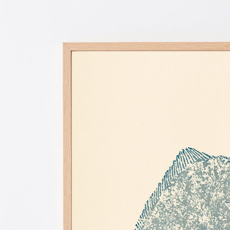 May include: A framed wall art piece featuring a textured, teal-colored fish illustration set against a solid cream-colored background. The artwork is enclosed within a light-toned wooden frame, showcasing a clean, simple design with visible grain.
