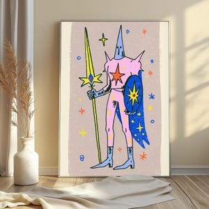 May include: A framed wall art print featuring a stylised illustration of a pink armoured figure with a tall pointed helmet, holding a long yellow spear and a blue shield, set against a light beige background with scattered colourful star motifs.
