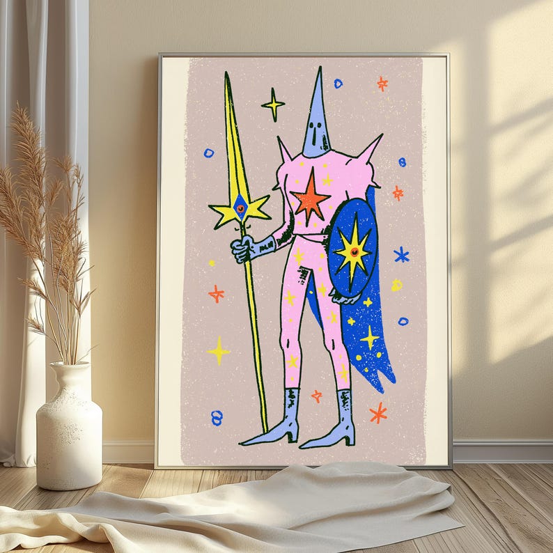 May include: A framed wall art print featuring a stylised illustration of a pink armoured figure with a tall pointed helmet, holding a long yellow spear and a blue shield, set against a light beige background with scattered colourful star motifs.