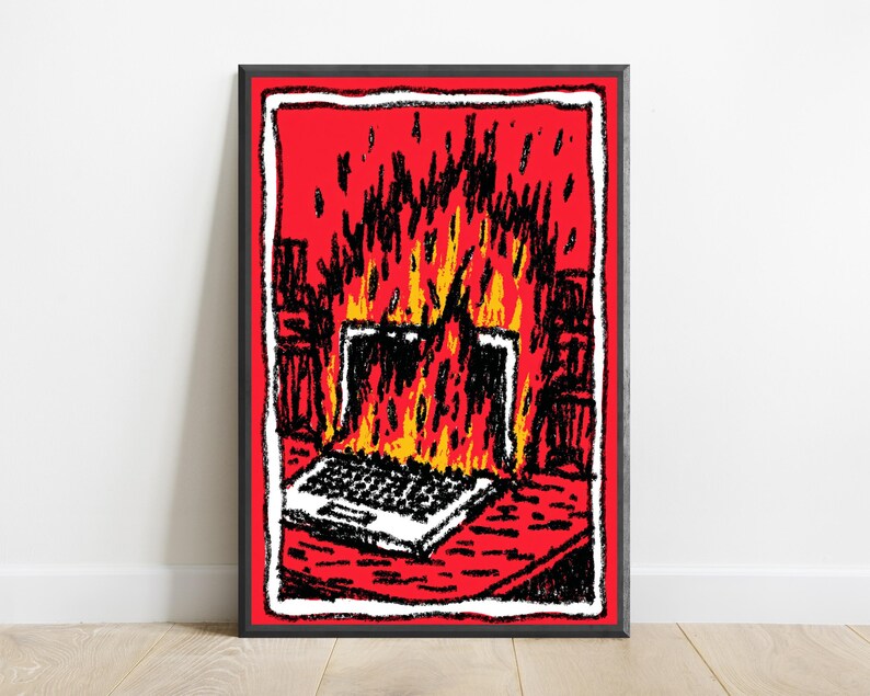 May include: A framed art print featuring a stylized illustration of a laptop engulfed in bright yellow and orange flames. The background is a vibrant red, and the entire scene is outlined with a thick, textured black and white border.