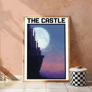 Puede incluir: Una impresi&oacute;n de arte p&iacute;xel enmarcada titulada THE CASTLE, que muestra la silueta oscura de un castillo sobre un acantilado frente a una gran luna llena brillante, con nubes p&uacute;rpuras y azules en un estilo de arte digital.