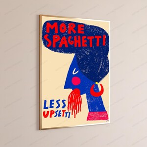 May include: A framed wall art print on a cream background featuring a blue stylized profile of a person with a large dark blue textured hairstyle. The text reads MORE SPAGHETTI at the top and LESS UPSETTI at the bottom in red, with red spaghetti.