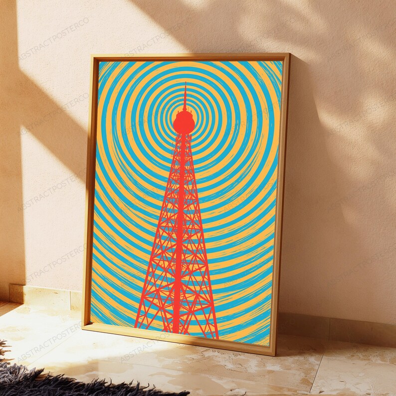 Puede incluir: Una impresi&oacute;n de arte mural rectangular enmarcada que presenta una torre de celos&iacute;a roja centrada sobre un fondo de c&iacute;rculos conc&eacute;ntricos en tonos alternos de amarillo brillante y azul cian, creando un patr&oacute;n gr&aacute;fico vibrante en el marco.