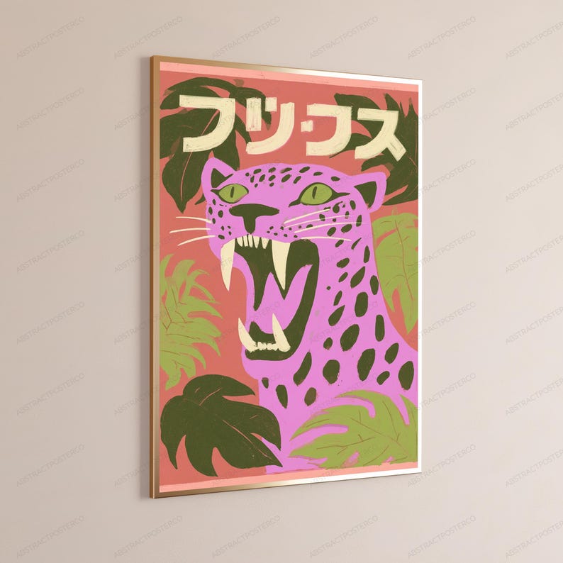 May include: A framed wall art print featuring a pink leopard with dark spots and an open mouth showing white teeth. The background is a coral red color with green tropical leaves and Japanese text in cream at the top of the rectangular composition.