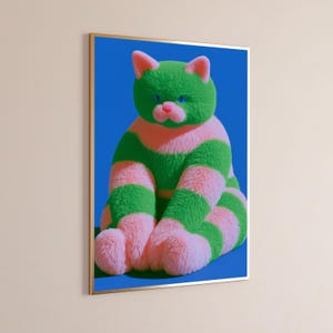 May include: A framed wall art print featuring a fluffy, stylized cat with horizontal stripes of vibrant green and soft pink fur. The cat has bright blue eyes and a pink nose, set against a solid, deep blue background within a thin gold frame.