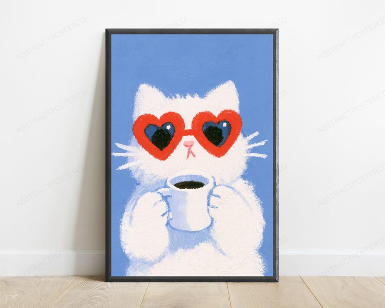 May include: A framed wall art print featuring a fluffy white cat against a solid blue background. The cat wears large red heart-shaped sunglasses and holds a white mug filled with dark coffee. The illustration has a textured, painterly style.