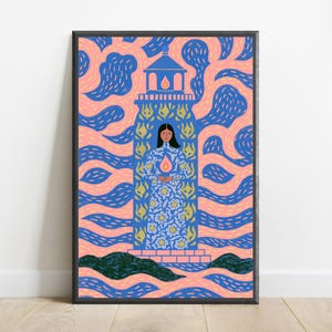 May include: A framed art print featuring a central lighthouse structure with a person standing inside, wearing a blue floral patterned dress and holding a glowing flame. The background consists of swirling pink and blue patterns with dark green hills.
