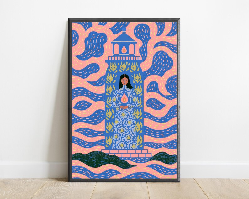 May include: A framed art print featuring a central lighthouse structure with a person standing inside, wearing a blue floral patterned dress and holding a glowing flame. The background consists of swirling pink and blue patterns with dark green hills.