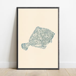 May include: A framed wall art print featuring a textured, blue-green illustration of a flatfish centered on a solid cream-colored background. The artwork is enclosed in a thin, dark-colored rectangular frame, presenting a clean and simple visual composition.