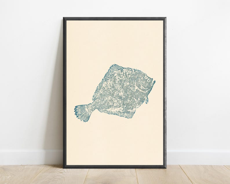 May include: A framed wall art print featuring a textured, blue-green illustration of a flatfish centered on a solid cream-colored background. The artwork is enclosed in a thin, dark-colored rectangular frame, presenting a clean and simple visual composition.