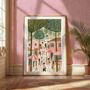 May include: A framed vertical art print depicting a bustling town square with pink buildings, tall green trees, and people walking on a cobblestone path. Several pink and white striped umbrellas are scattered throughout the scene under a soft light.