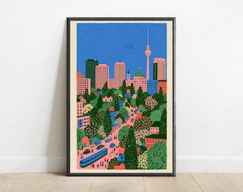 May include: A framed art print featuring a stylized cityscape illustration of Berlin. The scene depicts a blue sky, the TV Tower, and various buildings in pink and blue tones, set above a lush green park with trees, a blue tram, and people.