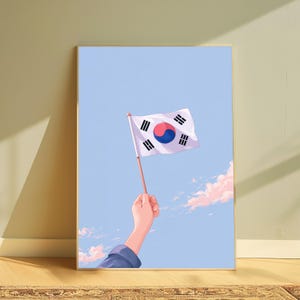 May include: A vertical art print featuring a hand holding a small South Korean flag against a light blue sky with soft pink clouds. The flag displays the central red and blue taegeuk symbol surrounded by four black trigrams on a white field.