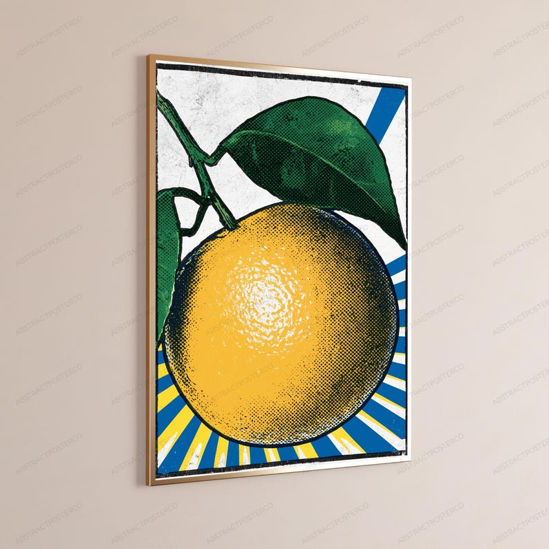 May include: A framed wall art print featuring a pop art style illustration of a yellow orange with green leaves. The background consists of blue and yellow radiating sunburst lines. The image has a textured, vintage halftone dot pattern.