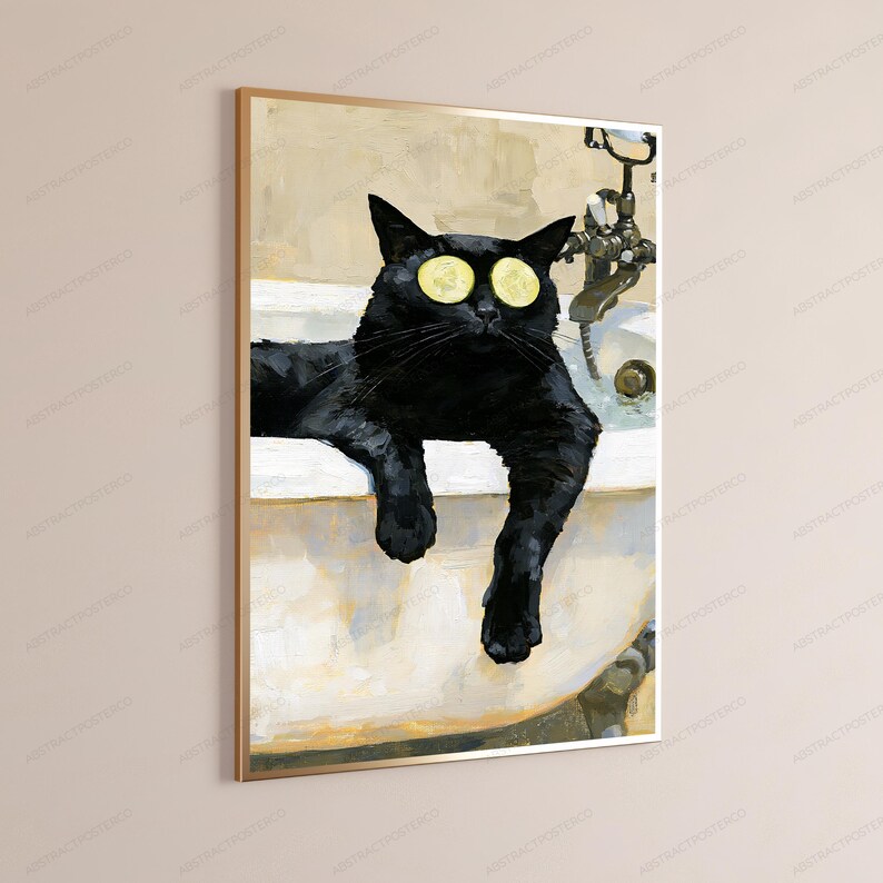 May include: A framed wall art print featuring a black cat resting in a white bathtub. The cat has two yellow cucumber slices placed over its eyes. A metallic faucet fixture is visible in the background, set against a neutral-toned wall.